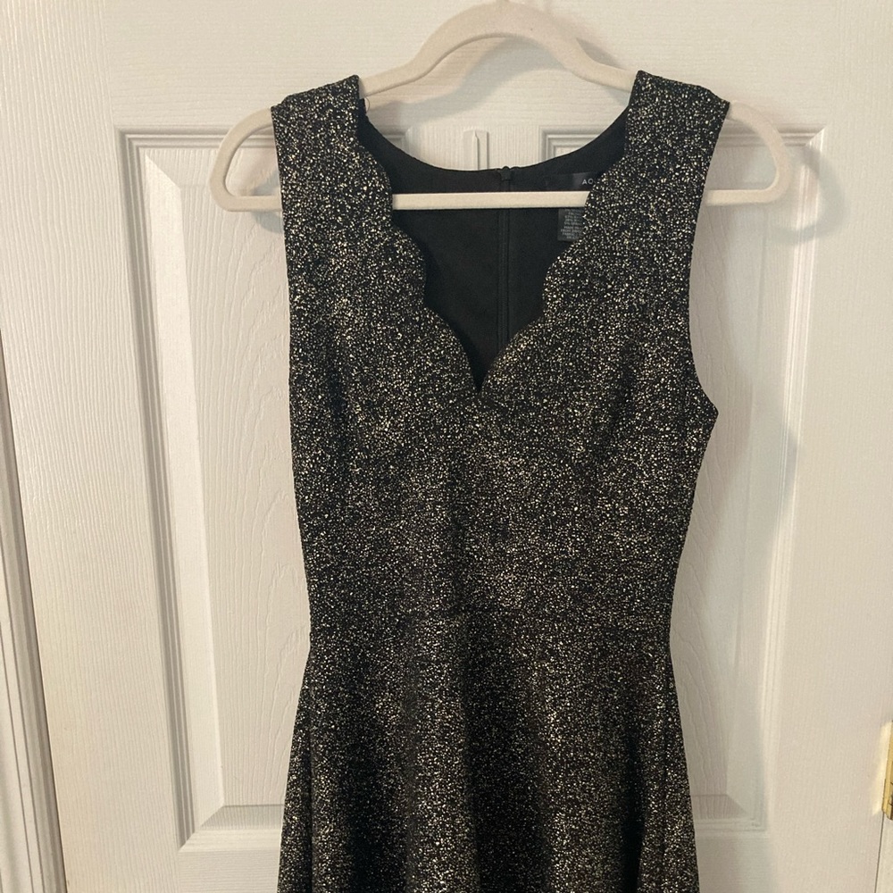 AQUA Black with gold sparkle/shimmer, scalloped neckline, falls above knee